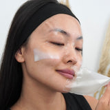 Woman removing LAPCOS overnight collagen sheet mask from face