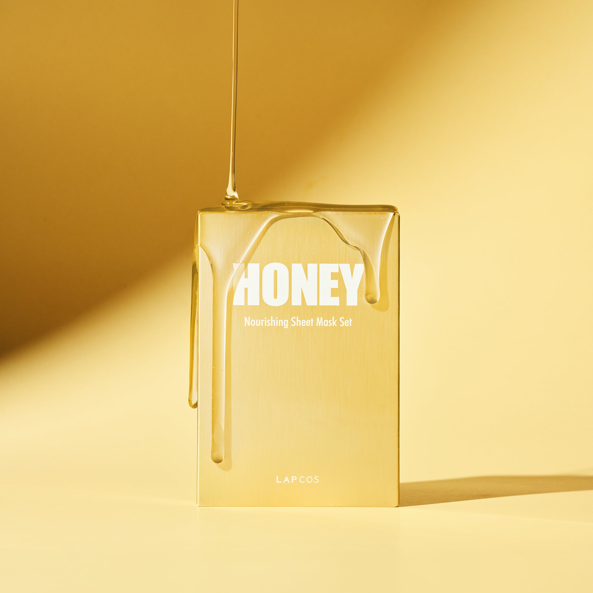 Box of honey sheet mask from LAPCOS with honey dripping on it